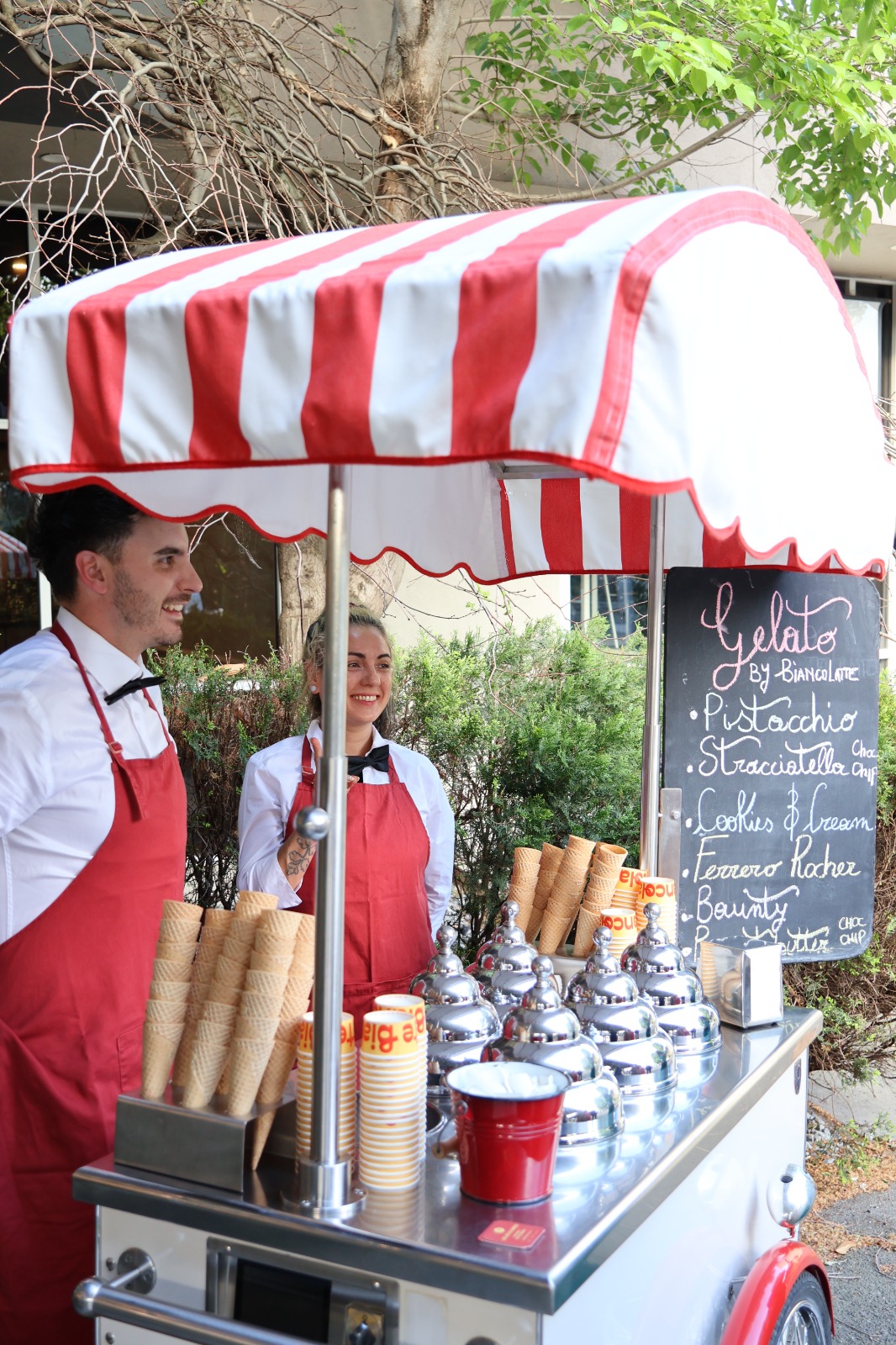 Gelato cart with striped canopy and servers