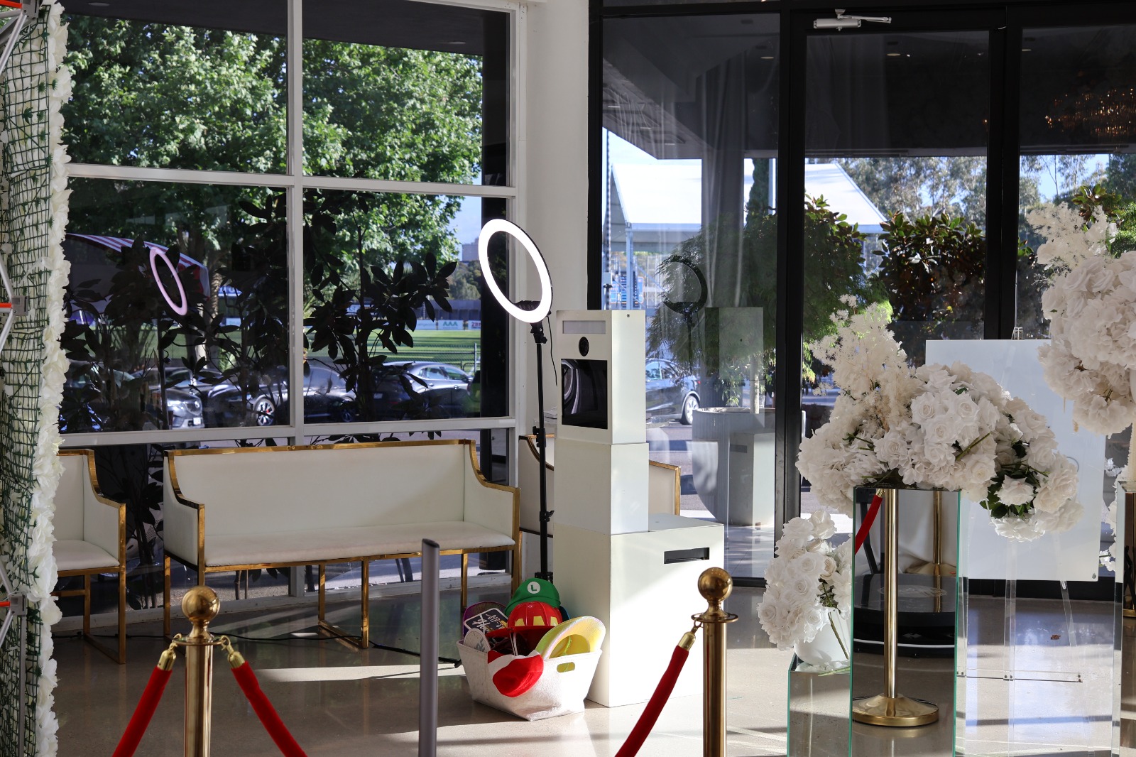 Venue lounge with florals, ring light and gold stanchions