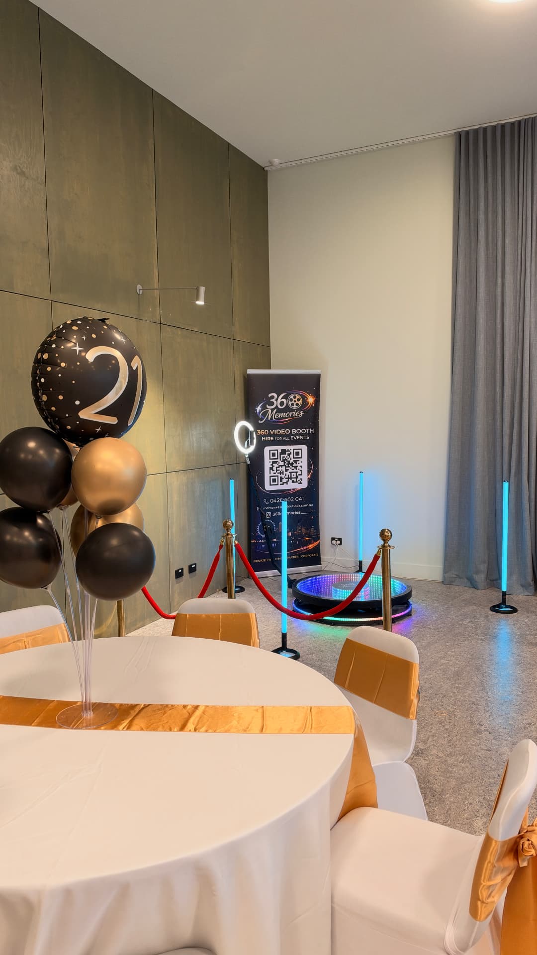 360 video booth beside black and gold balloons at a 21st birthday celebration