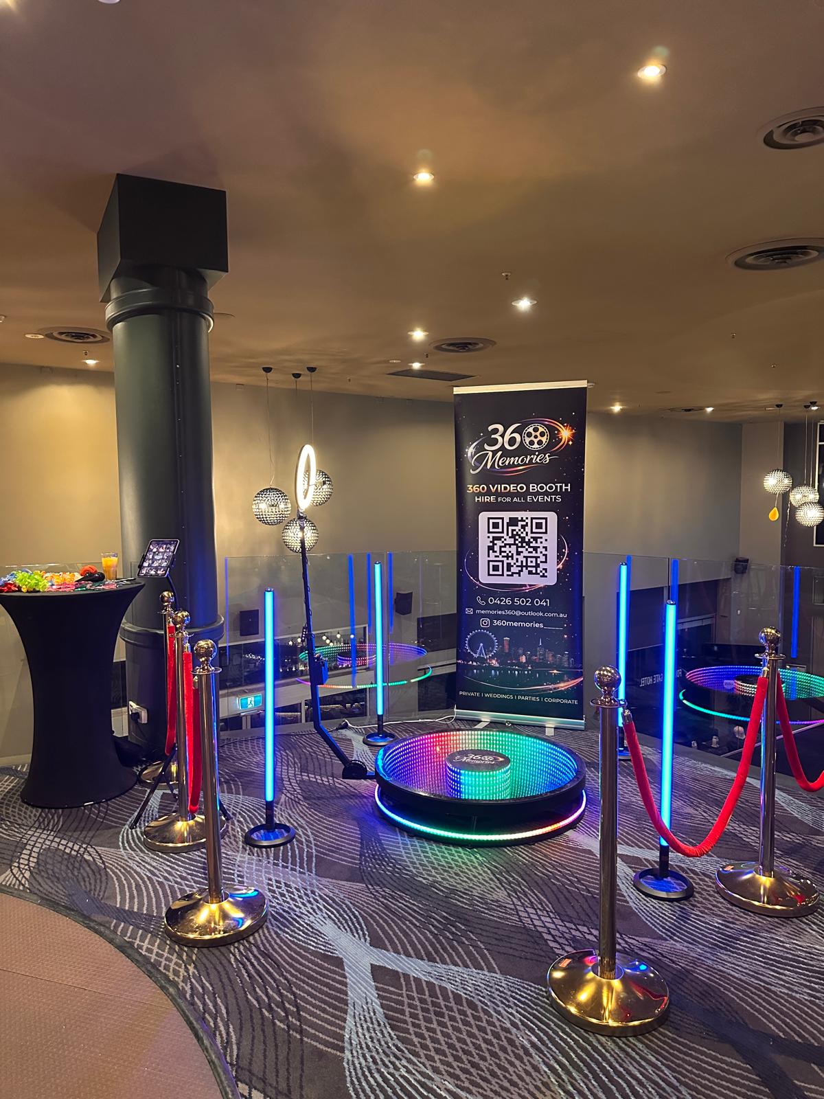 360 video booth setup with LED tubes and gold stanchions