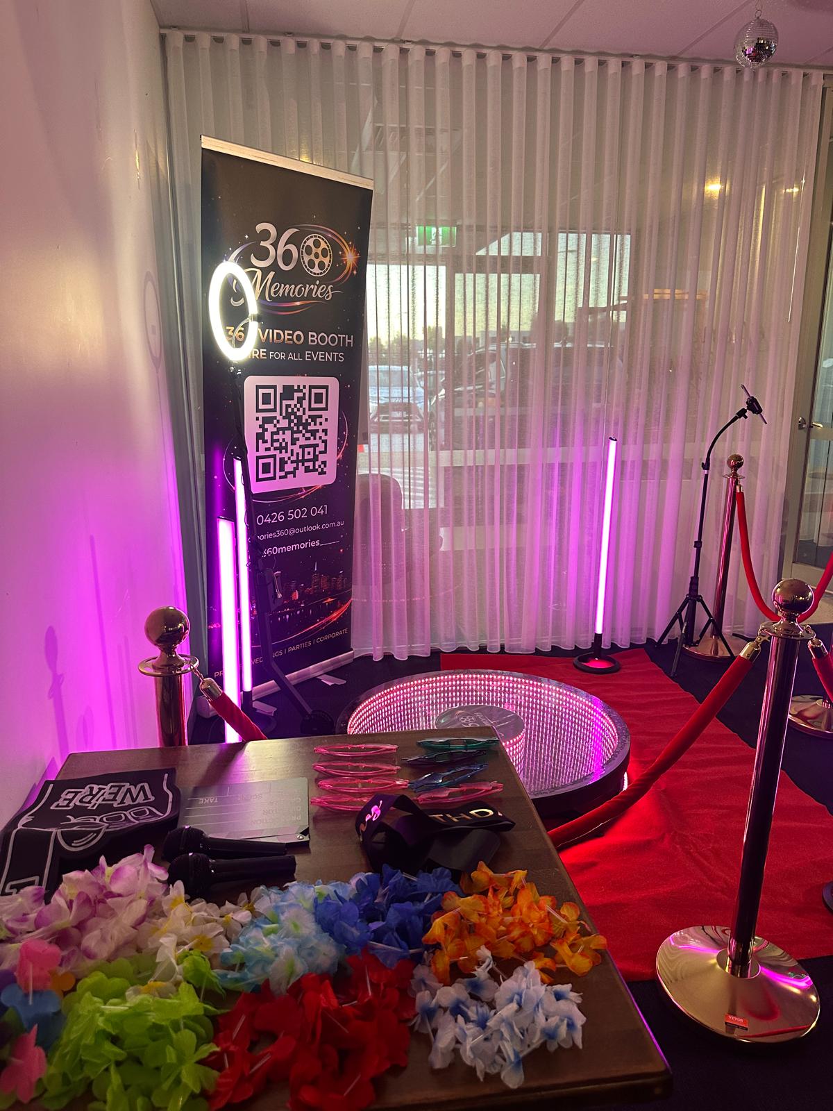 360 booth with prop table and floral leis
