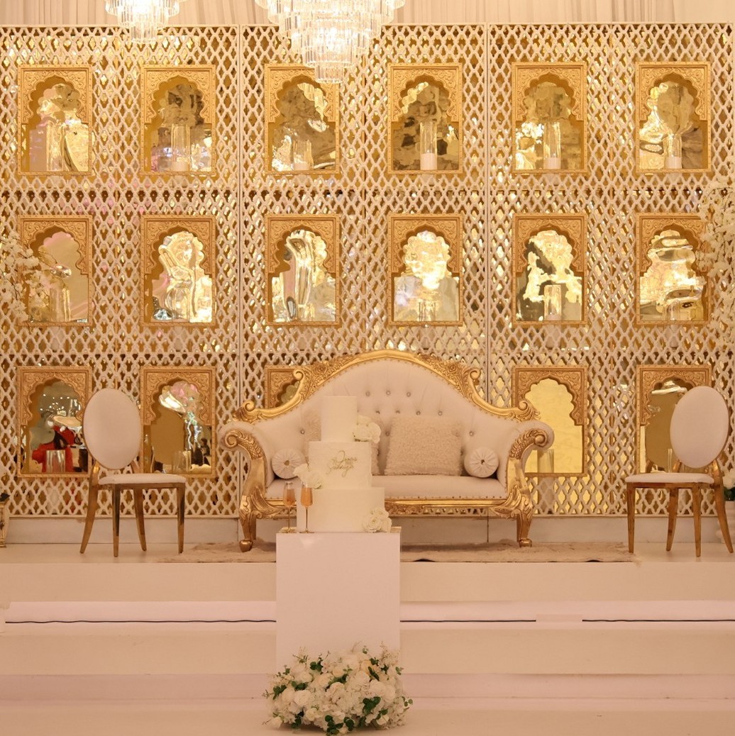 Gold lattice stage with white sofa and cake